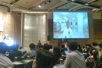 In TSMC's July 2009 earnings call, Liu was seen wearing a white lab coat on the projection screen. Credit: DIGITIMES